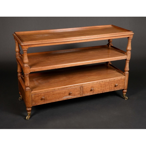 1649 - A Victorian mahogany rounded rectangular low three-tier buffet, shallow gallery, the base with a pai... 