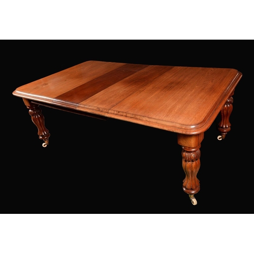 1652 - A Victorian mahogany wind-out dining table, rounded rectangular moulded top with two leaves, above a... 