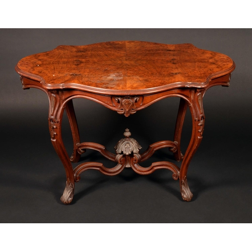 1662 - A Victorian burr walnut shaped oval centre table, quarter veneered moulded top above a shaped frieze... 