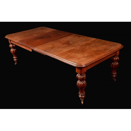 1669 - A William IV/early Victorian mahogany rounded rectangular wind-out dining table, moulded top above a... 