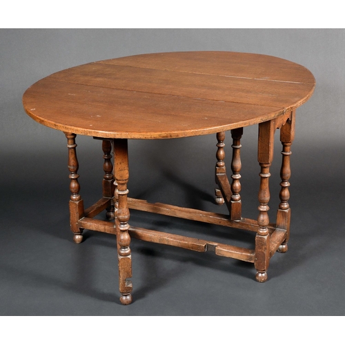 1673 - An 18th century style gateleg dining table, c. 1950