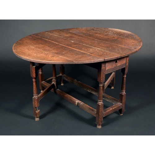 1679 - An early 18th century oak gateleg dining table, turned legs, 72cm high, 128cm long,  116cm wide, c.1... 