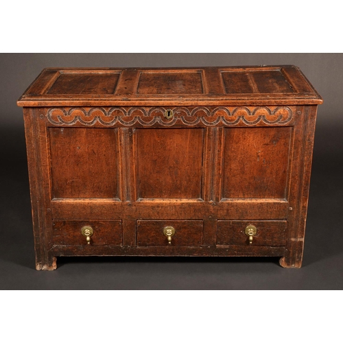 1680 - An early 18th century oak three-panel mule chest, hinged top above a deep frieze carved with a band ... 