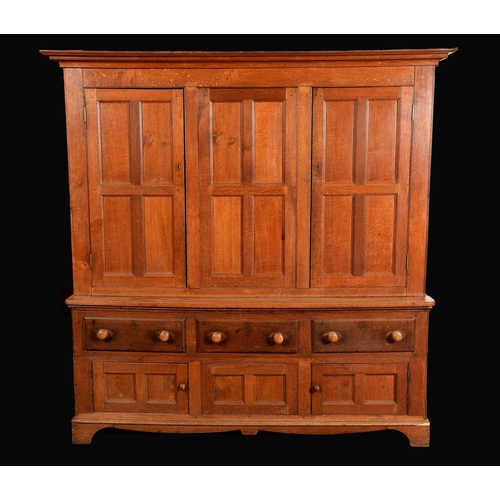 1685 - An early Victorian oak housekeeper's cupboard, moulded outswept cornice above a pair of panelled doo... 