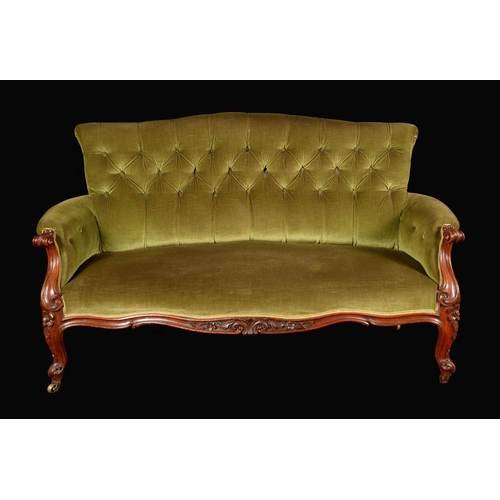 1686 - An early Victorian rosewood sofa, stuffed-over deep-buttoned upholstery, the frame well carved with ... 