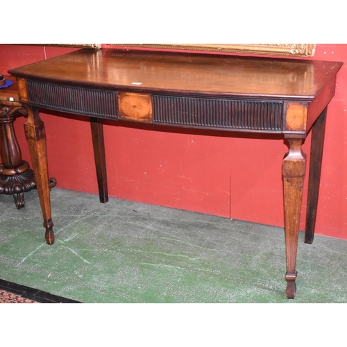 1687A - A George III mahogany serving table, slightly bowed top with deep frieze with two fluted drawers and... 