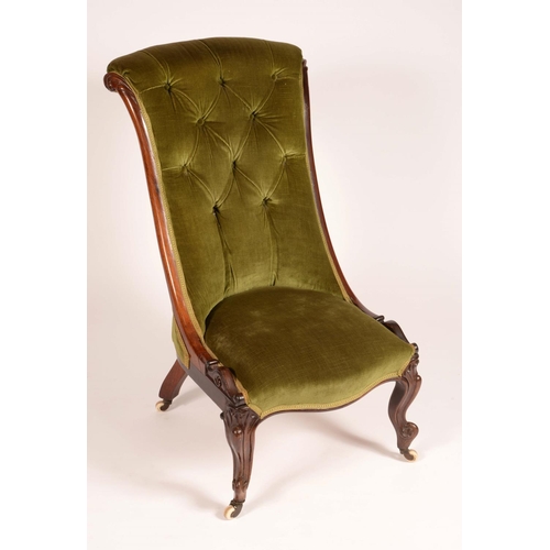 1701 - An early Victorian mahogany nursing chair, deep buttoned stuffed over upholstery, carved with scroll... 