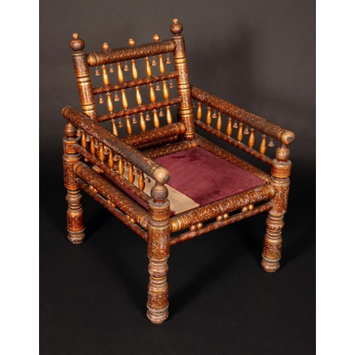 1704 - A 19th century Indian penwork chair, spindle back and arms, turned legs, decorated overall with gilt... 