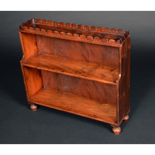 1709 - A George IV mahogany table top waterfall bookcase, shaped gallery, turned feet, 55cm high, 61cm wide... 