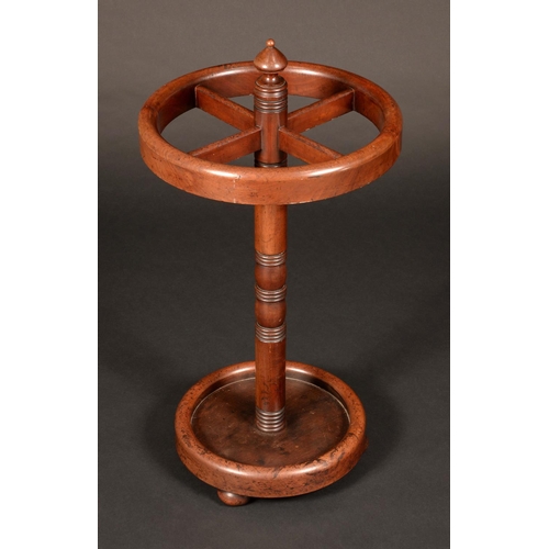 1710 - A Victorian mahogany circular four section walking stick stand, turned column, dished base, bun feet... 