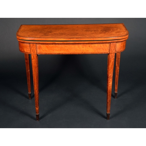 1713 - A George III satinwood D-shaped card table, folding top above a deep frieze, tapered square legs, sp... 