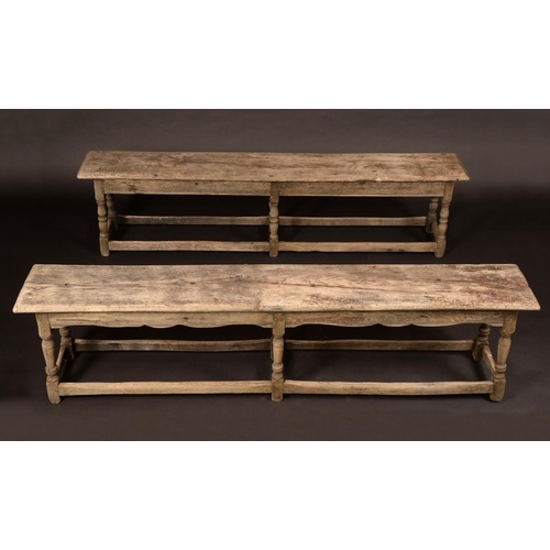 1714 - A pair of early 18th century oak long benches, of joined construction, wavy aprons, turned legs, rec... 