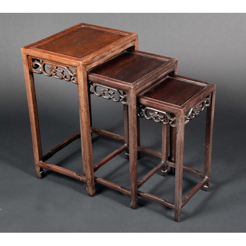 1715 - A nest of three early 20th century Chinese padouk side tables, rectangular fielded tops, scrolls fre... 