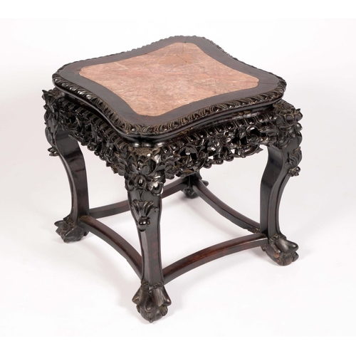 1717 - A Chinese padouk incurved square jardiniere stand, the top inset with soapstone, above a deep frieze... 