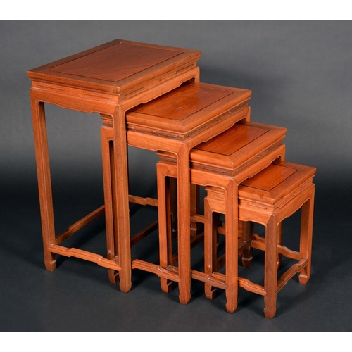 1719 - A set of Chinese hardwood quartetto tables, rectangular panelled tops, shaped friezes and stretchers... 