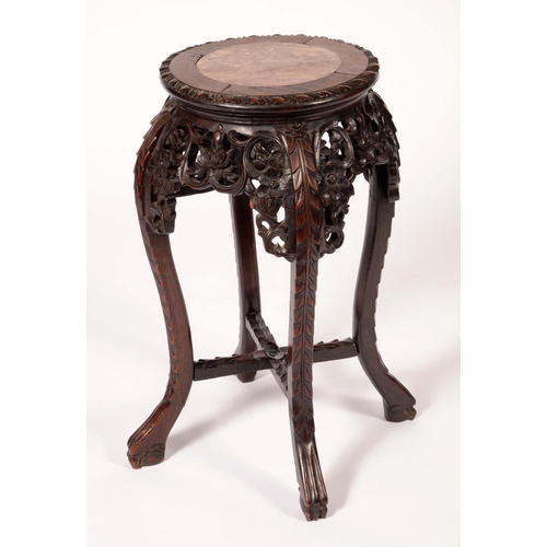 1721 - A Chinese padouk wood jardiniere stand, the top with inset soapstone roundel, shaped apron pierced a... 