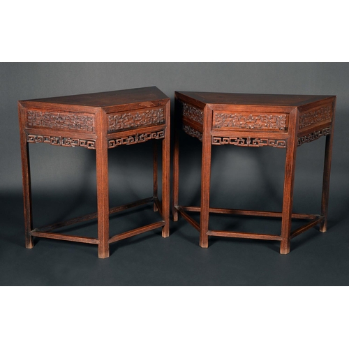 1726 - A pair of Chinese hardwood canted rectangular side tables, each with panelled top above a deep friez... 