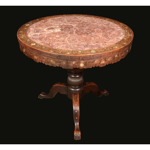 1729 - A 19th century Chinese padouk wood tripod centre table, soapstone inset top above a deep shaped frie... 