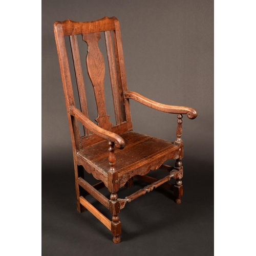 1741 - An 18th century walnut armchair, rectangular back with vasular splat, scroll arms, boarded seat, tur... 