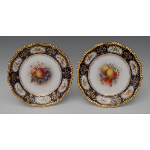 195 - A pair of Royal Worcester shaped circular plates,  painted by H. Martin, signed, with fruit and blos... 