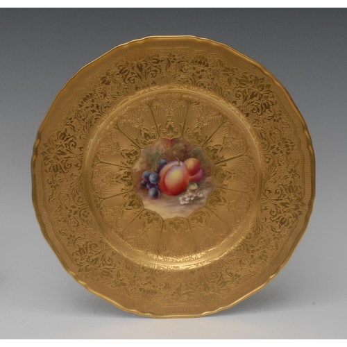 200 - A Royal Worcester shaped circular plate painted by J. Freeman, signed with ripe fruit, tooled and et... 