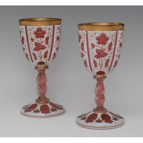 215 - A pair of 19th century cranberry and white overlaid goblets, etched with flowers and foliage, double... 