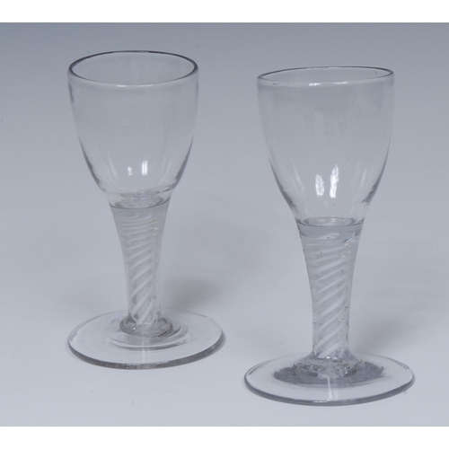 216 - A pair of George III opaque twist wine glasses, ovoid bowls, double-helix stems, domed circular feet... 