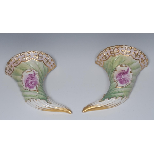 239 - A pair of Continental cornucopia wall pockets, decorated in puce with cherubs and garland of flowers... 