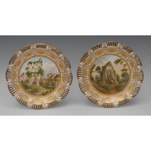 68 - A pair of Coalport shaped circular plates, with pierced border,  painted with Abbey Ruins Abbey of L... 