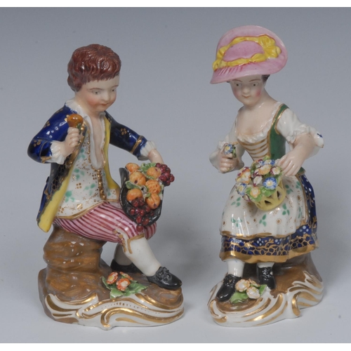 82 - A pair of Derby figures, of a Fruit and Flower Sellers, he with fruit in his upturned ha, she with a... 