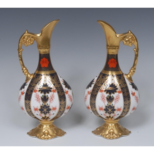 97 - A pair of Royal Crown Derby 1128 pattern Kedleston ewers, gilt spouts, handles and quatrefoil bases,... 