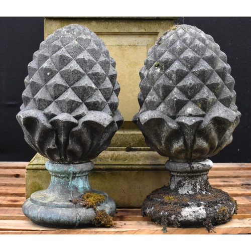 1424 - A pair of 18th century style composition pine cone pier-finials, waisted socles, 64cm high