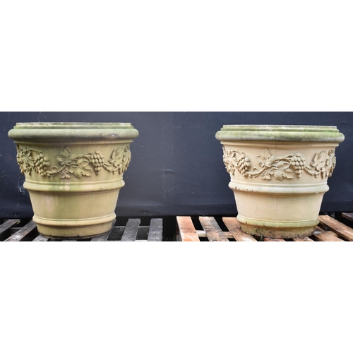 1429 - A pair of Regency design composition bucket-shaped garden urns, each applied with a broad band of fr... 