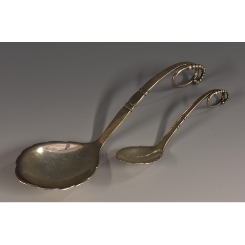 18 - Georg Jensen - a Danish silver pattern No.41 serving spoon, planished overall, 19cm long, import mar... 