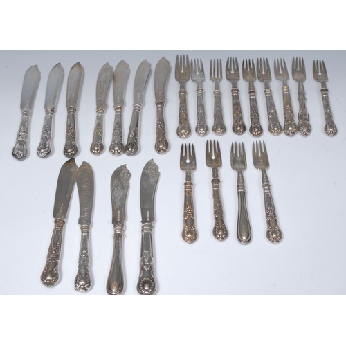 25 - A composed set of silver hafted Kings pattern fish knives and forks, the blades engraved with scroll... 