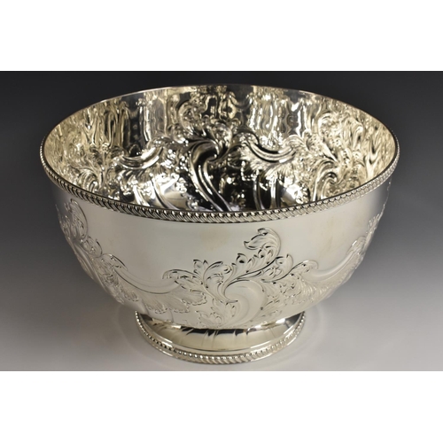 3 - A large Victorian style E.P.N.S pedestal punch bowl, half wrythen-fluted and embossed with scrolling... 