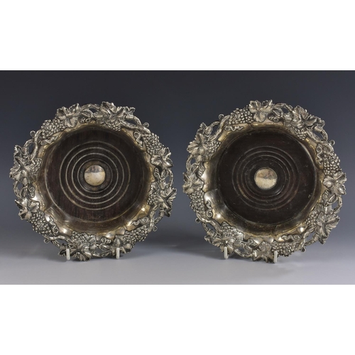 5 - A pair of post-Regency Sheffield plate fluted shaped circular wine coasters, fruiting vine borders, ... 