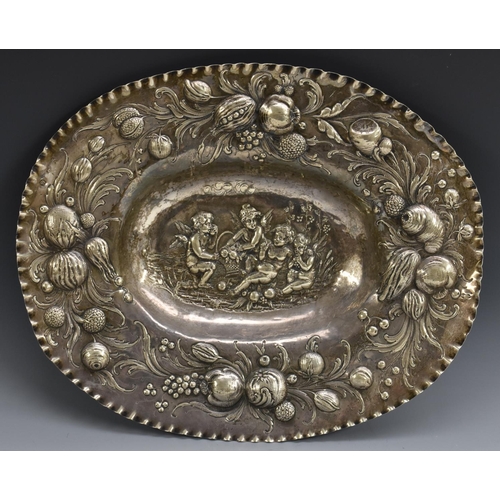 52 - A Continental silver oval sideboard dish, chased with frolicking putti,  within a band of fruiting f... 