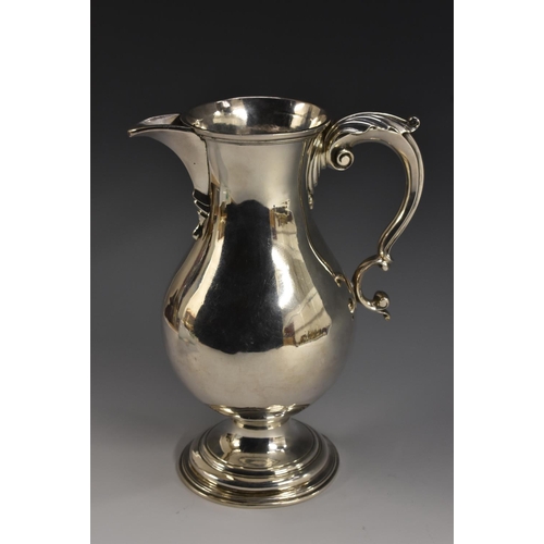 67 - A George II silver baluster beer jug, acanthus-capped double scroll handle, raised circular foot, 22... 