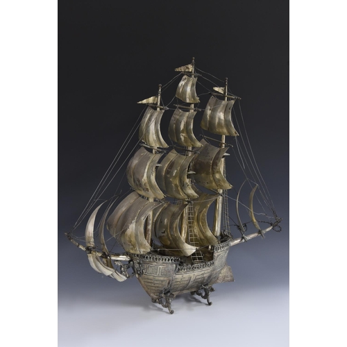 9 - A large Continental silver coloured metal nef, the three masts with billowing sails, figures on deck... 