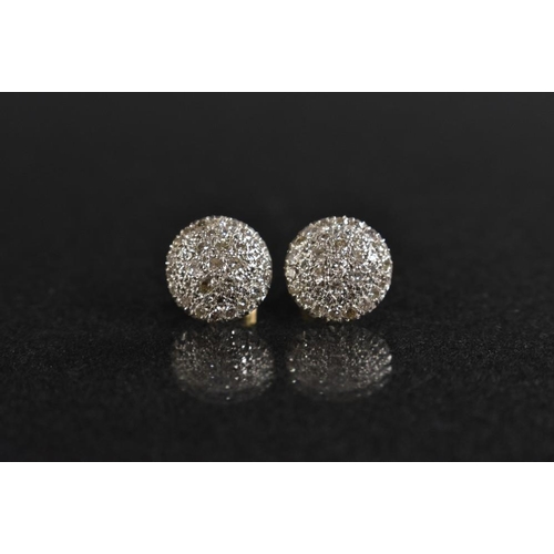 3157 - A pair of diamond encrusted circular shield earrings, each pave encrusted with approx forty three ro... 