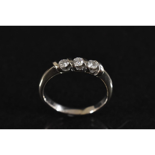 3174 - A diamond trilogy ring, three round brilliant cut diamonds, each divided by a shaped wave crest bar,... 