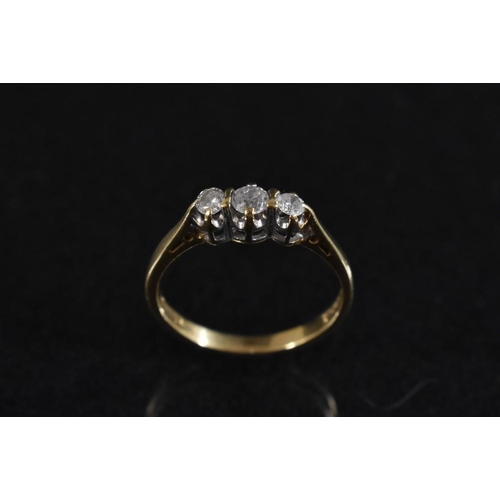 3175 - A diamond trilogy ring, central round brilliant cut diamond approx 0.12ct, flanked by a smaller conf... 