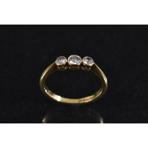 3184 - A diamond trilogy ring, linear set with three round graduated brilliant cut diamonds, total estimate... 