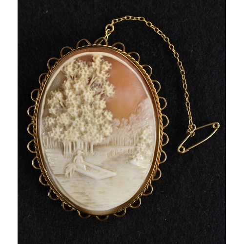 3186 - A 9ct gold mounted oval carved shell cameo brooch, landscape with figure seated upon the back of a S... 