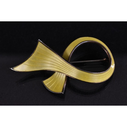 3189 - Ivar T Holth - a Norwegian silver and yellow enamel ribbon brooch, papering overlapping vibrant yell... 