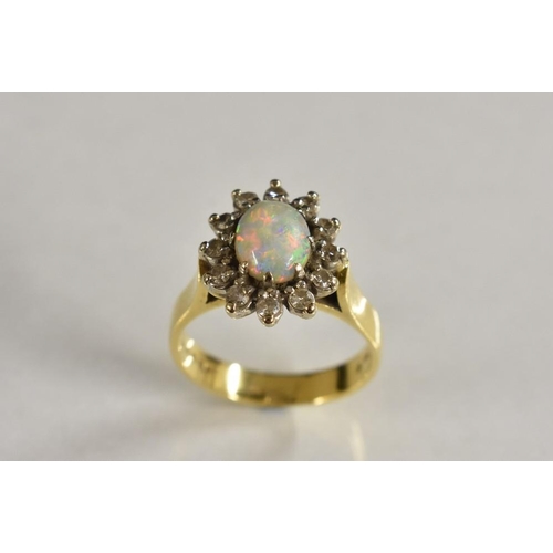 3195 - An opal diamond and white sapphire cluster ring, central oval opal cabochon surrounded by a band of ... 