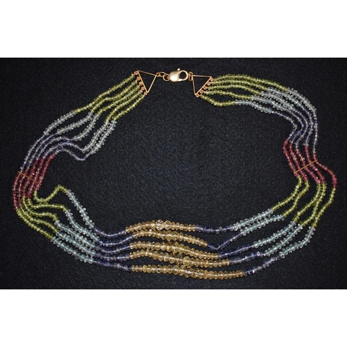 3208 - A five stand multi gemstone bead necklace, tapering graduated strands threaded with panels of multi ... 