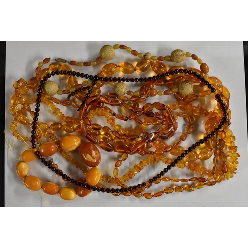 3219 - A single strand amber coloured bead necklace; others river washed, cherry etc, assorted sizes and co... 