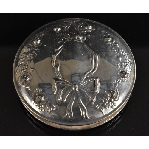 3373 - A silver compact, decorated in relief with ribbon and bow, kid leather case